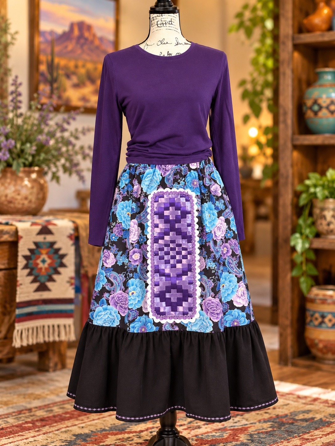 Blue and purple floral skirt with a woven purple front panel and black ruffle, styled with a purple top that is not included